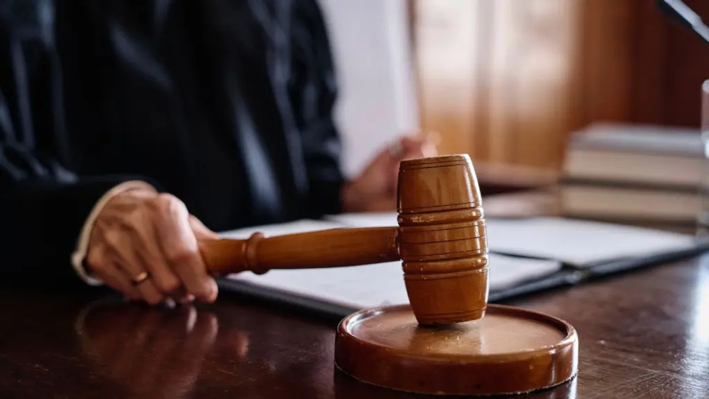 A judge banging their gavel in the courtroom.