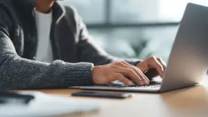 A man on his laptop doing research. 