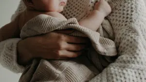 A mother holding her baby. 