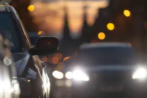 Cars driving with high beams on. 