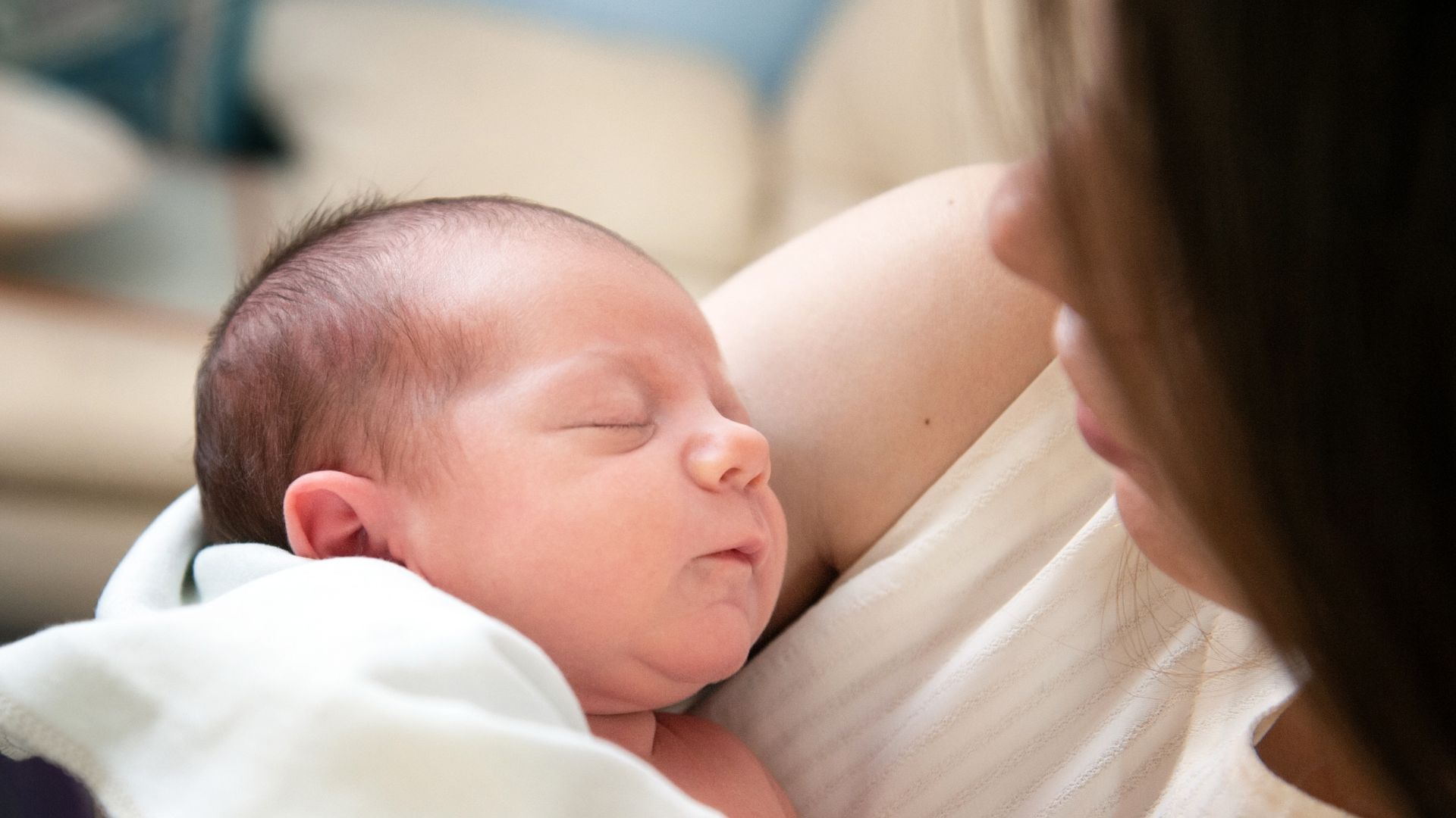 A mother holding her newborn baby. 