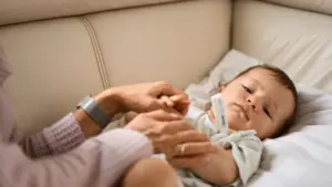A parent taking care of a sick baby.