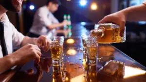 A person pouring shots for a customer.