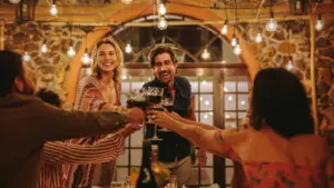 Two party hosts making a toast to everyone invited. 