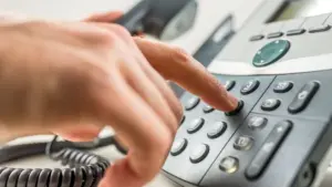 A person dialing the phone. 